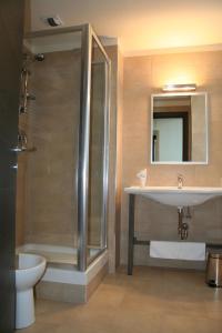 a bathroom with a shower and a sink and a toilet at Hotel Verdina in Volpiano +25 photos