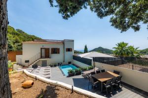 a villa with a swimming pool and a house at Sestel in Capdepera