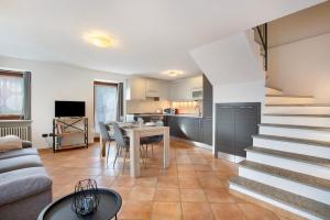 a living room with a table and a kitchen at Tra Montagna e Città - Aosta in Aosta
