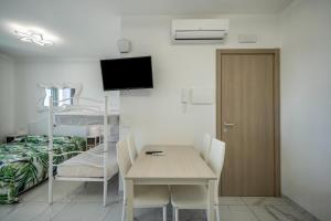 a hospital room with a table and a bunk bed at Planet Suite 504 in Bibione