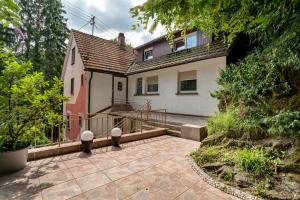 a house with a patio in front of it at Gästehaus 22 in Baden-Baden