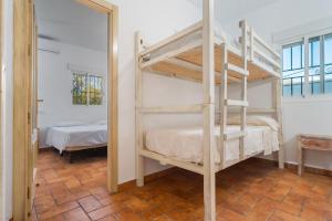a bedroom with two bunk beds and a mirror at Valle Verde in Morón de la Frontera +22 photos