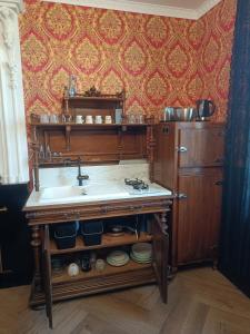 a kitchen with a sink and a counter top at Le Making Of Chambres d'Hôtes insolites et Familiales in Thairé