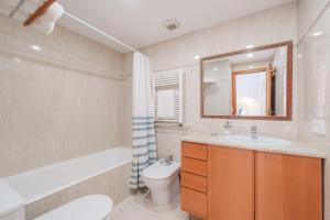 a bathroom with a sink and a toilet and a mirror at Ca Na Luisa-Residential Area in Palmanova +24 photos