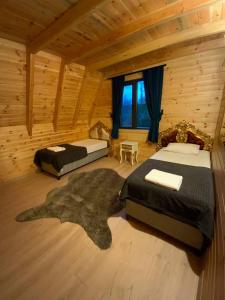 Un dormitorio con dos camas en una cabaña de madera. en Moon Bungalov, en Sapanca