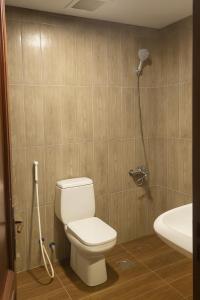 a bathroom with a toilet and a shower at فيلا برادايس in Jeddah