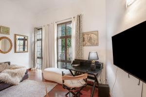 a living room with a tv and a desk at Suitme Teror in Teror