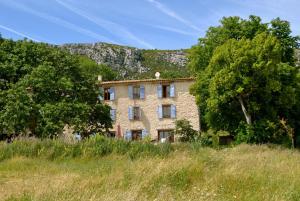 an old stone building in the middle of trees at Gite Bastide in Bargème