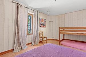 a bedroom with a bunk bed and a chair at Gite Bastide in Bargème