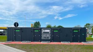 a gas station with four green doors on the side at Roatel Emden A31 my-roatel-com in Emden
