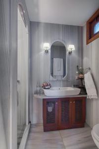 a bathroom with a sink, toilet and bathtub at Hotel Empress Zoe in Istanbul
