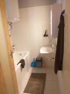 a bathroom with a sink and a tub and a toilet at Tomi Vendégház in Kóczántanya