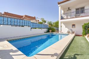 a swimming pool in the backyard of a house at El Escondite in Alcaucín