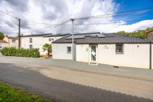 a white house on the side of a road at Gîte Les Gats in Saint-Hilaire-le-Vouhis