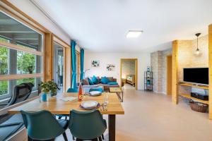 a living room with a table and chairs and a couch at Ferienwohnungen Kätzlehaus in Meßstetten