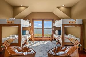 two bunk beds in a room with a balcony at Pinnacle Pointe by Relaxtay 600 Acre Private Luxury Estate with Spa, Pool, Theater and Lake in High View +162 photos