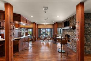 a living room with a stone wall and a fireplace at Pinnacle Pointe by Relaxtay 600 Acre Private Luxury Estate with Spa, Pool, Theater and Lake in High View