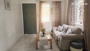 un salon avec un canapé et une table basse dans l'établissement Feel Borneo Cozy Homestay in Penampang, à Penampang