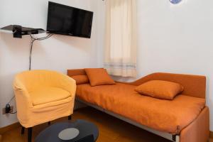 a living room with a couch and a chair at Seahouserent in Cannigione