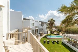 a balcony view of a villa with a swimming pool at Ninemia Suites Tinos Grand 204 in Kionia