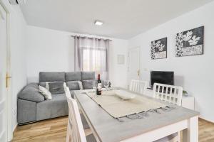 a living room with a table and a couch at Casa Loli in Frigiliana