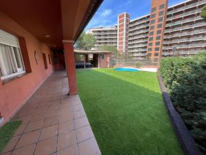 an empty courtyard of a building with a lawn at La Caseta de Sant Pol in Sant Feliu de Guixols