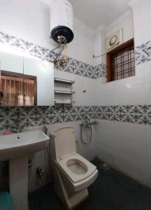 a bathroom with a toilet and a sink at 2BHK Central Gurgaon in Gurgaon