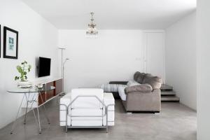 a living room with a couch and a chair at Casa La Concha Lanzarote in Playa Honda
