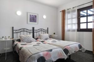 a bedroom with two beds and a window at Apartamento Acogedor in Puerto del Carmen