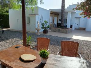 a wooden table and chairs in a yard at Casa Susana in Santa Eularia des Riu