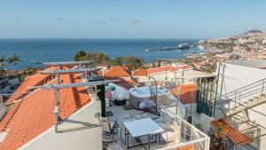 a balcony with a view of the ocean and buildings at Sissi Lanço View 7 in Santa Luzia