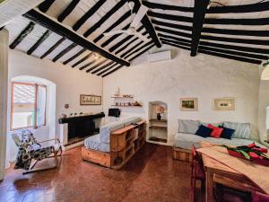a living room with a couch and a table at Il Borgo 5 in Capoliveri