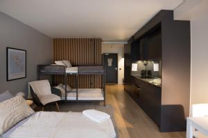 a small room with a bed and a kitchen at HOOM Home & Hotel Järfälla in Järfälla