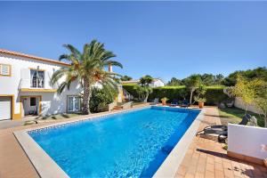 a swimming pool in the backyard of a house at Villa Oliveira in Aljezur