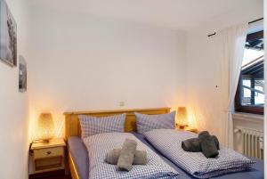 a bedroom with two beds with stuffed animals on them at Almzeit in Farchant