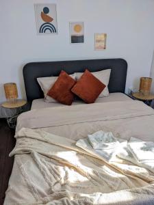 a bed with pillows and a blanket on it at Honey I`m home Apartments in Veliko Tŭrnovo +66 photos