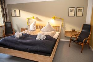 a bedroom with a large bed and two chairs at Fuglsang Have B&B 