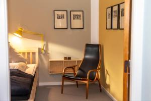 a room with a chair and a desk and a bed at Fuglsang Have B&B 