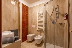 a bathroom with a shower and a toilet and a sink at Matera Castle Suite in Matera