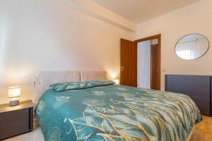 a bedroom with a bed with a blue comforter at Matera Castle Suite in Matera
