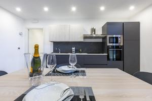 a kitchen with a table with wine glasses on it at Casa Gioiosa Holidays in Gioiosa Marea