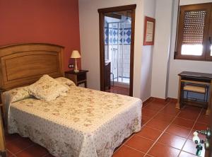a bedroom with a bed and a door to a balcony at Casa de la Calle el Pozo in Pina de Montolgrao +24 photos