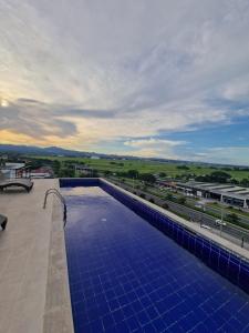 a swimming pool on the roof of a building at A cozy and spacious Studio apartment Angeles city pampanga in Angeles +6 photos