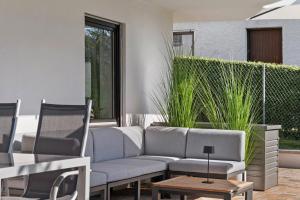 a patio with a couch and a table and chairs at Ferienwohnung Mayer in Albstadt