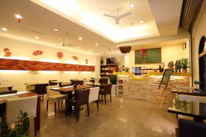 a dining room with tables and chairs in a restaurant at Love in Hualien B&B in Hualien City