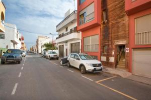a white car parked on the side of a city street at Casa Castilla in Puerto del Rosario