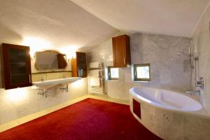 a bathroom with a large tub and a sink at Emmat Apartments in Leutasch +28 photos