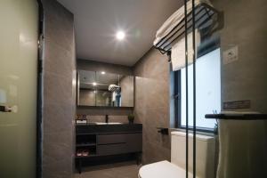 a small bathroom with a toilet and a window at Ha Fa Villa in Hong Kong +30 photos