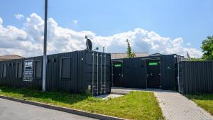 a row of black shipping containers with a bird sitting on top at Roatel Hirschberg an der Bergstraße (A5) my-roatel-com in Hirschberg an der Bergstraße
