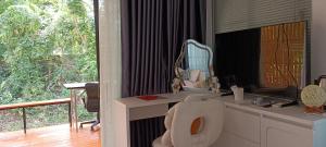 a bathroom with a sink and a mirror on a counter at Lhong Luk Khao Camping in Ban Khlong Kathon